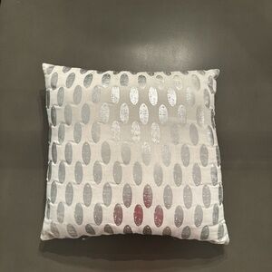 White and silver cushion throw pillow.